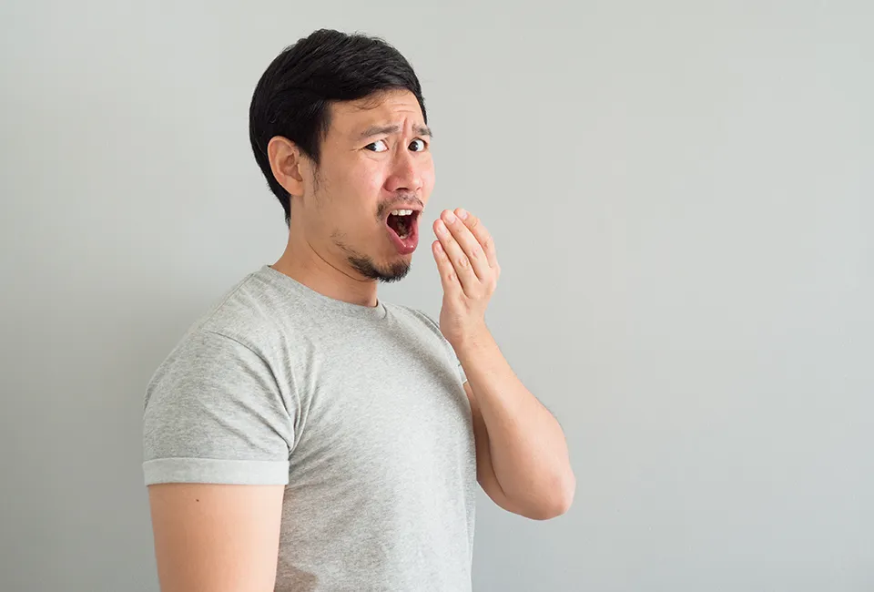 Patient smelling his breath